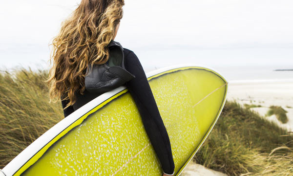 Surfer with board on beach